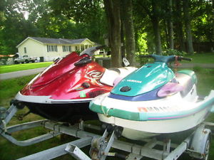 2012 and 1995 jet ski with double trailer.