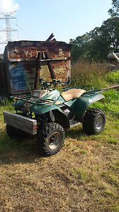 Polaris 4 x 4 300 cc quad 2 stroke front and rear racks good tyres needs work
